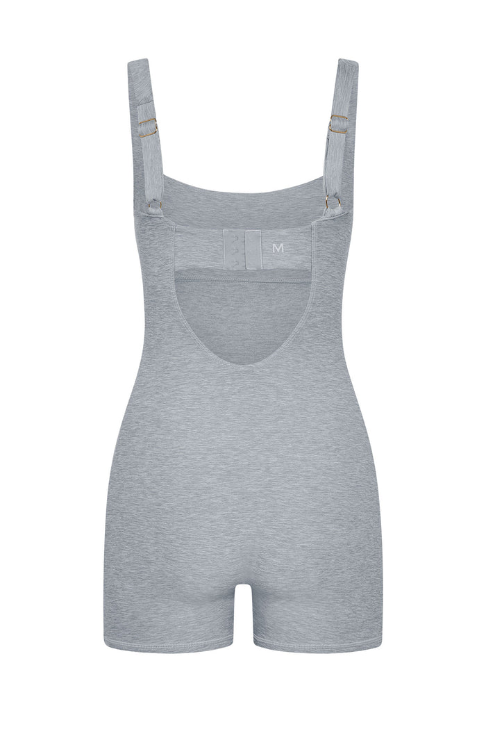 Front view of Zion Romper in heather gray showcasing adjustable straps with gold hardware, scoop neckline, and shaping shorts on white background