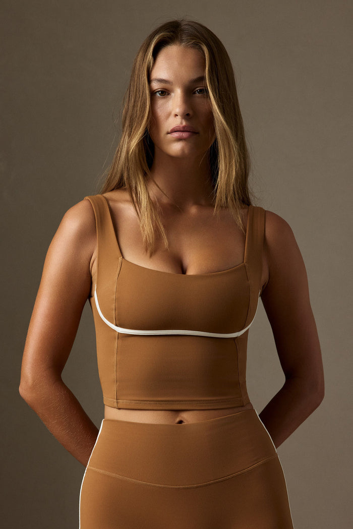 Front view of Zion Tank in Caramel/Ivory showing square neckline, contour seams and ivory piping on neutral background